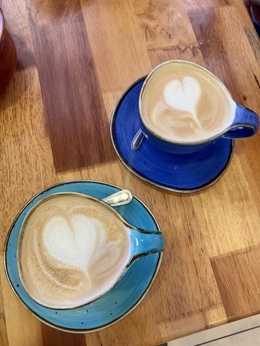 Two mugs with latte art.